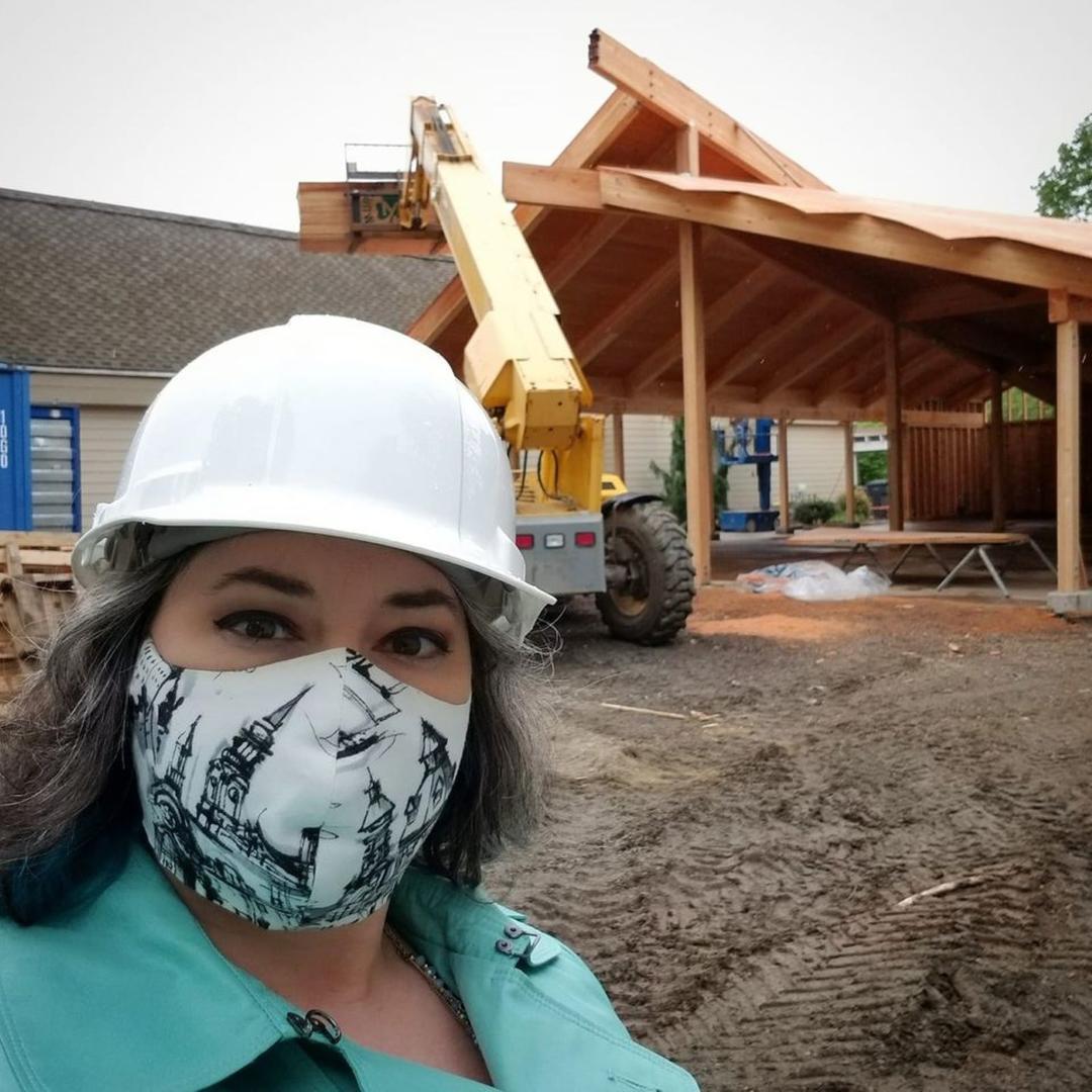 Ellen Krusi stands in front of the Charbonneau Pavilion under construction.