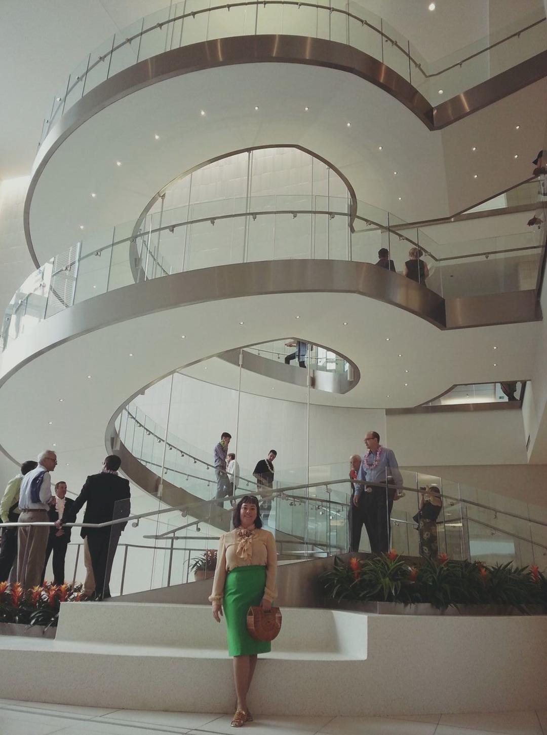 Ellen Krusi stands in front of a 3-story spiral staircase at Lloyd Center Mall in 2017