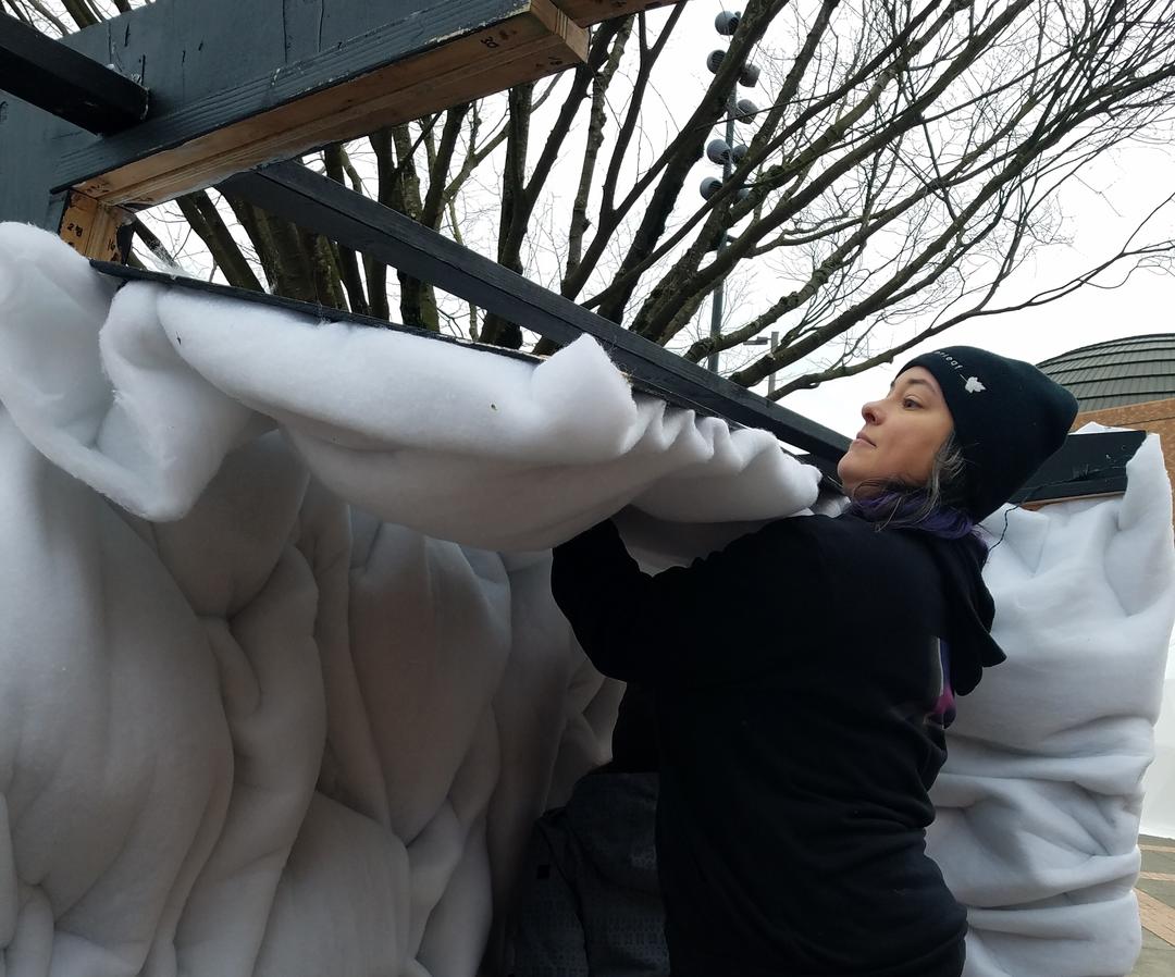 Ellen Krusi assembling a panel for the Portland Winter Light Festival art installation